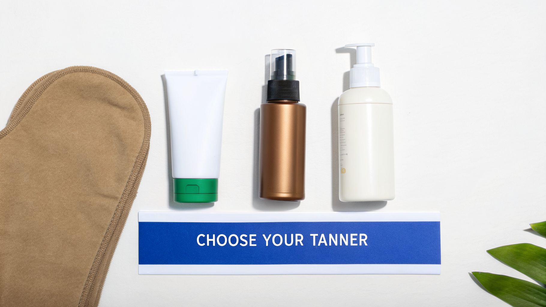Three self-tanner bottles, a tanning mitt, and a 'Choose Your Tanner' sign.