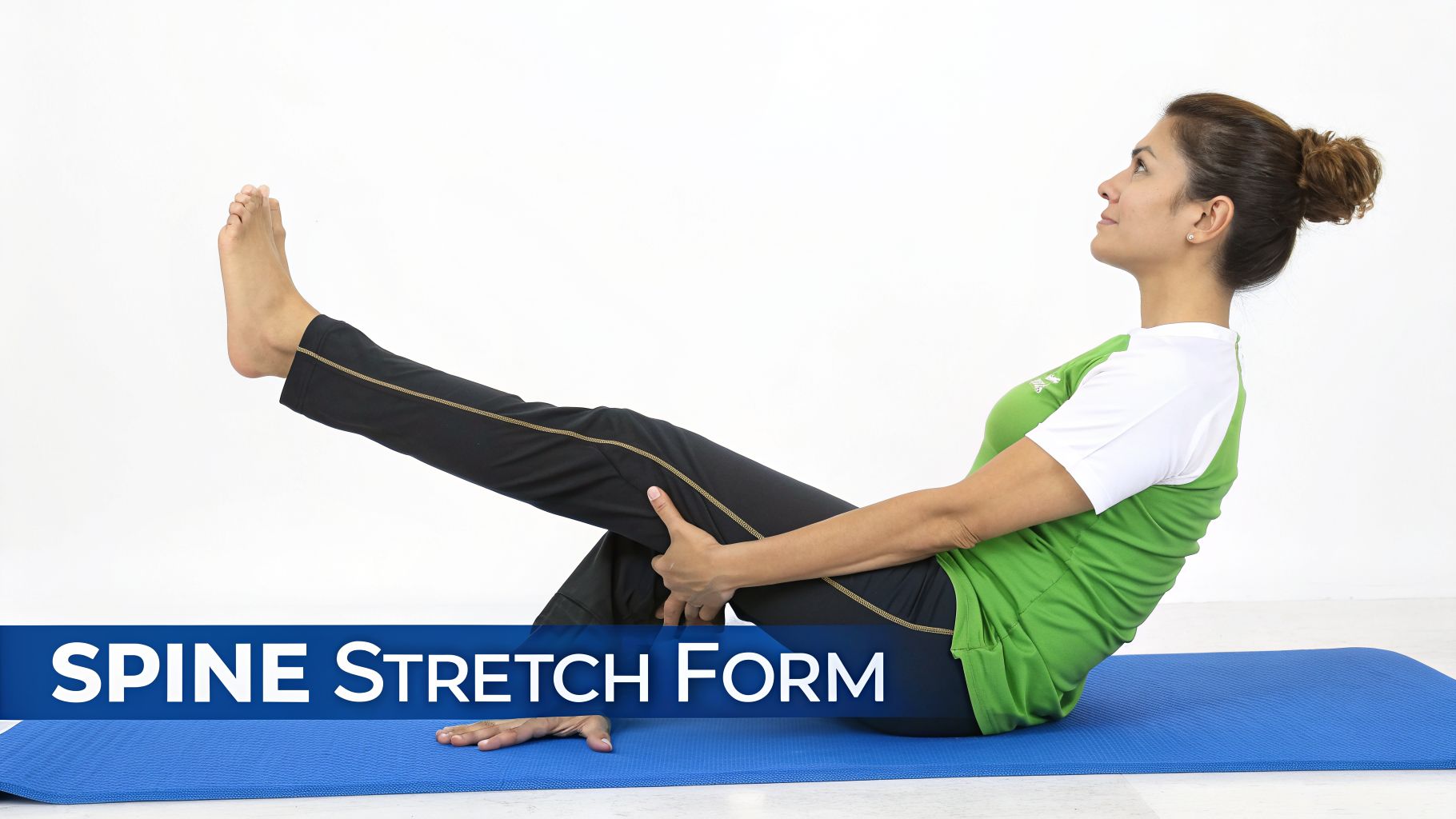 A woman performs a spine stretch pilates exercise on a blue mat, looking up.