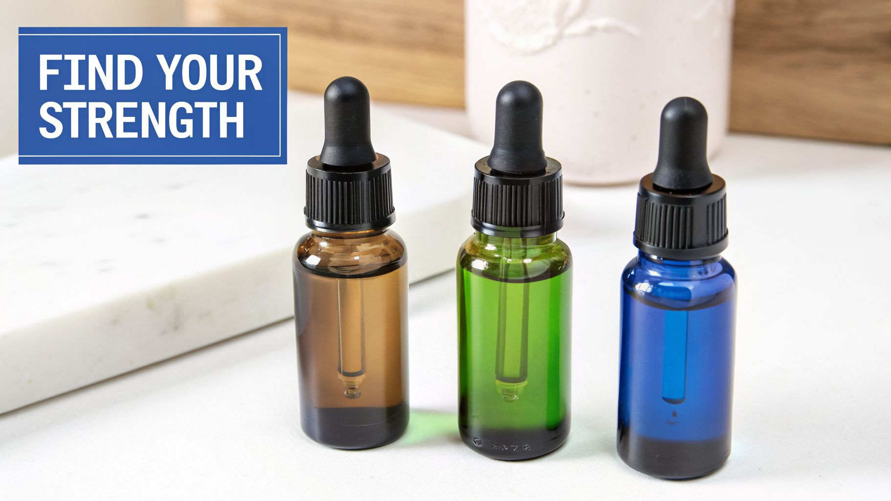 Three amber, green, and blue dropper bottles on a white surface, with text 'FIND YOUR STRENGTH'.